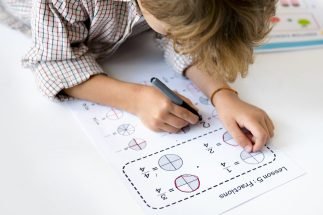 Kid Concentrating with Mathematics Homework Learning